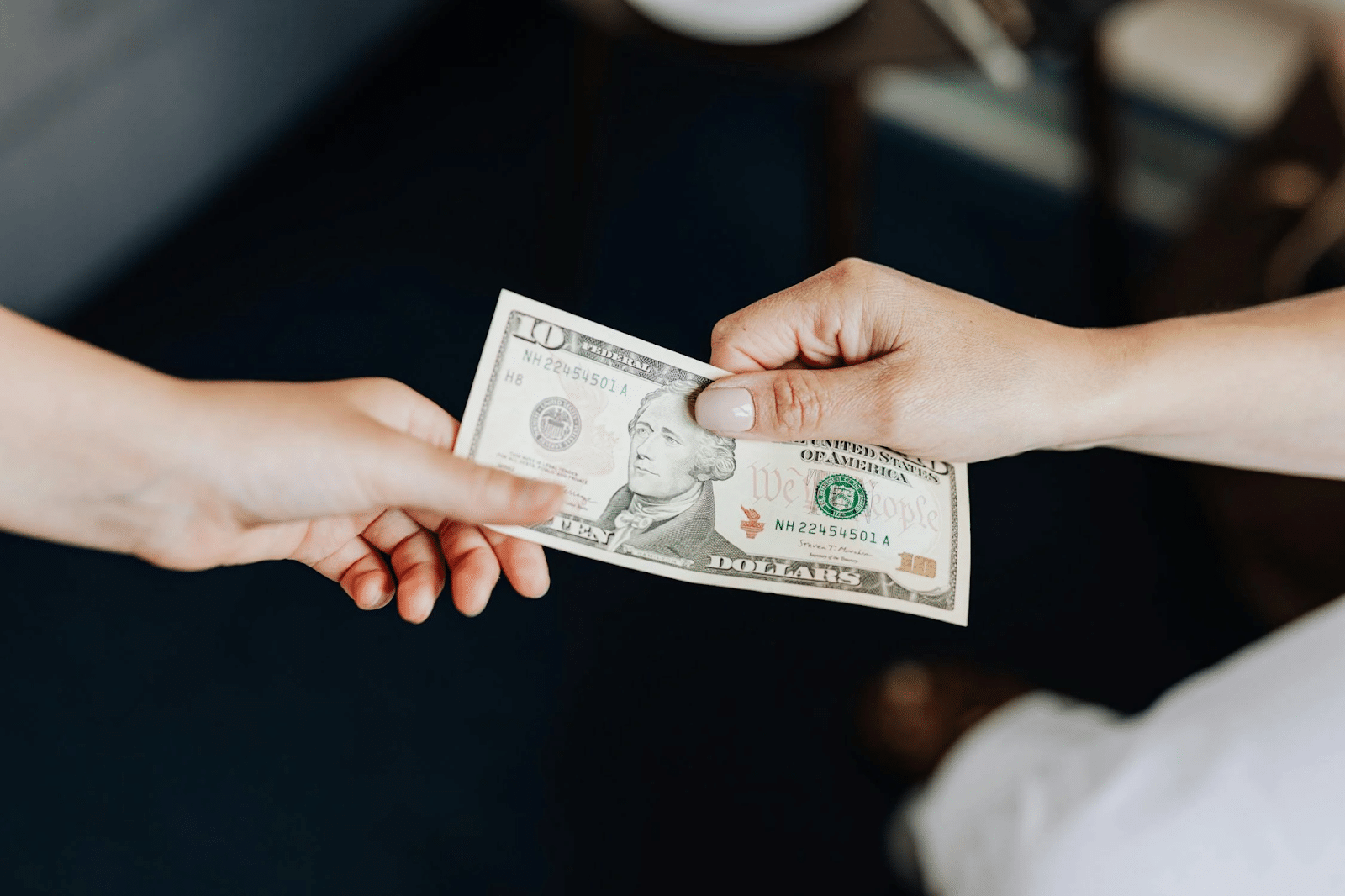 a ten dollar bill handed to a closer