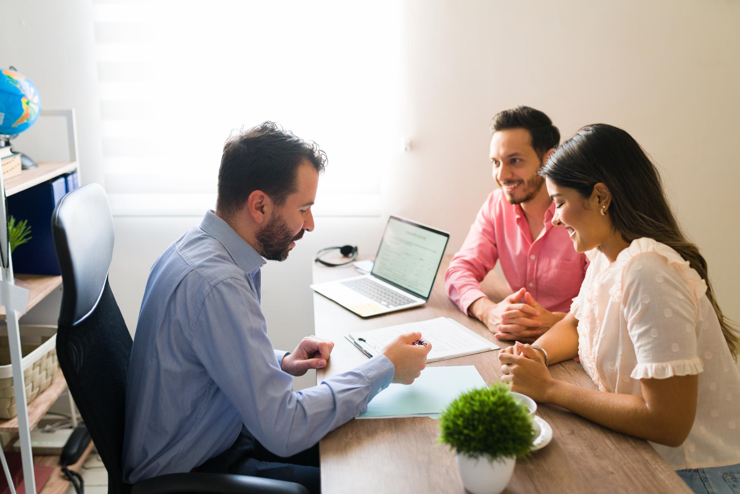 Couple meeting with mortgage advisor discussing Texas FHA home loans and affordable financing options for homebuyers.