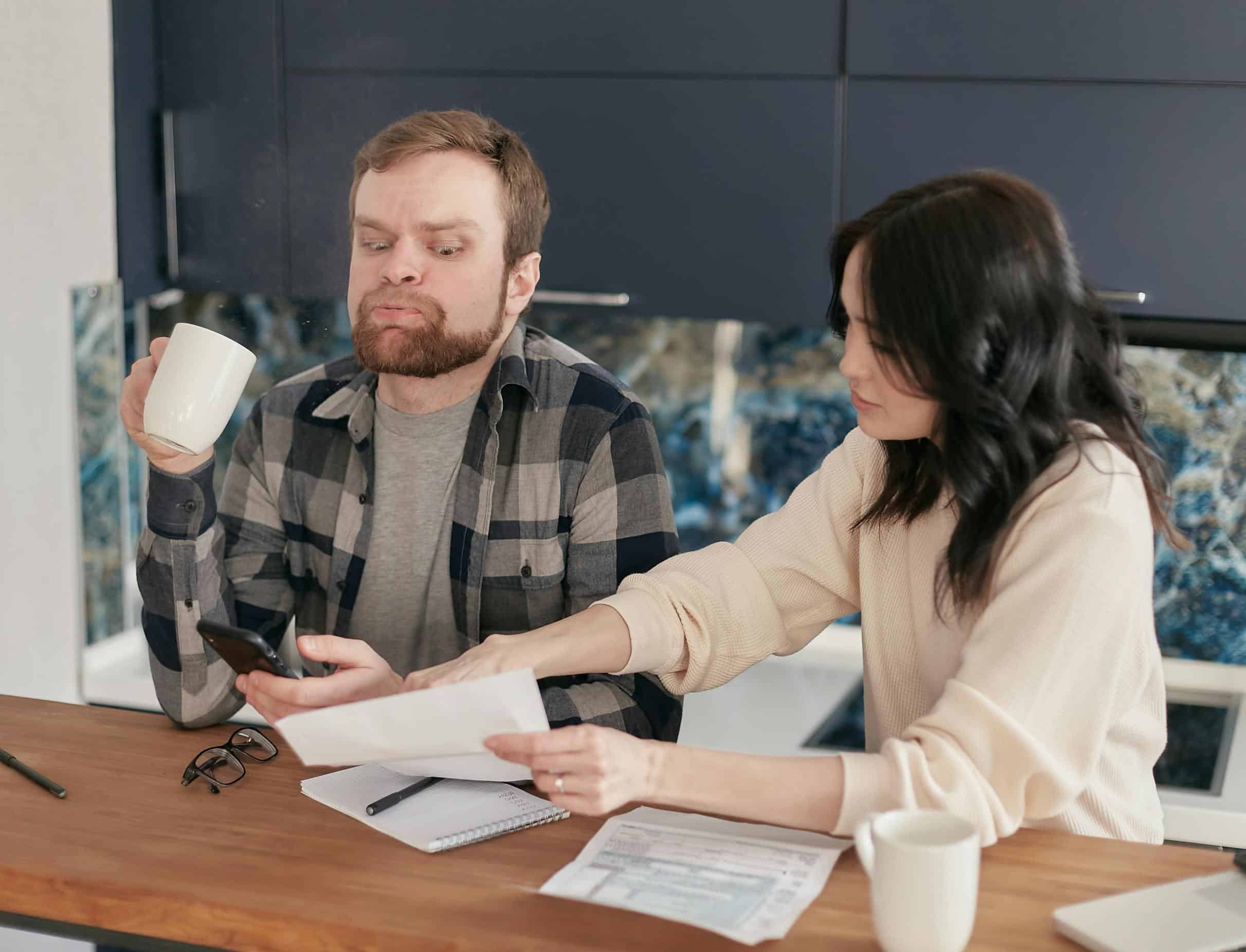 Couple reviewing mortgage paperwork for Texas FHA Streamline Refinance to reduce monthly payments and simplify refinancing.