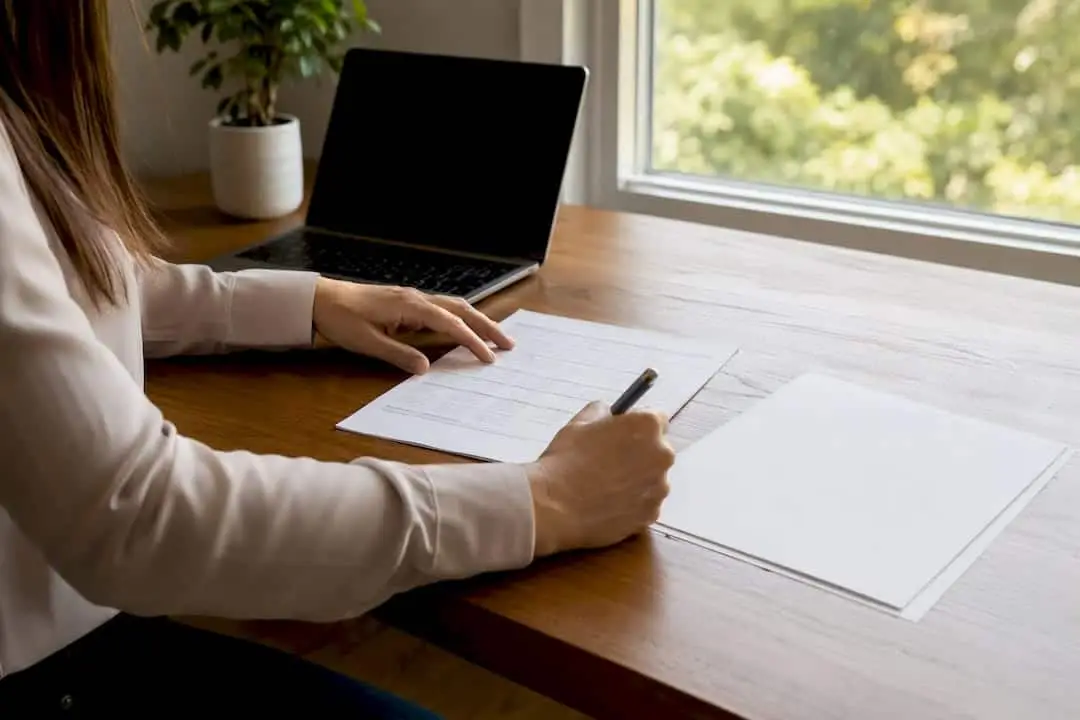 Hands organizing FHA income documents