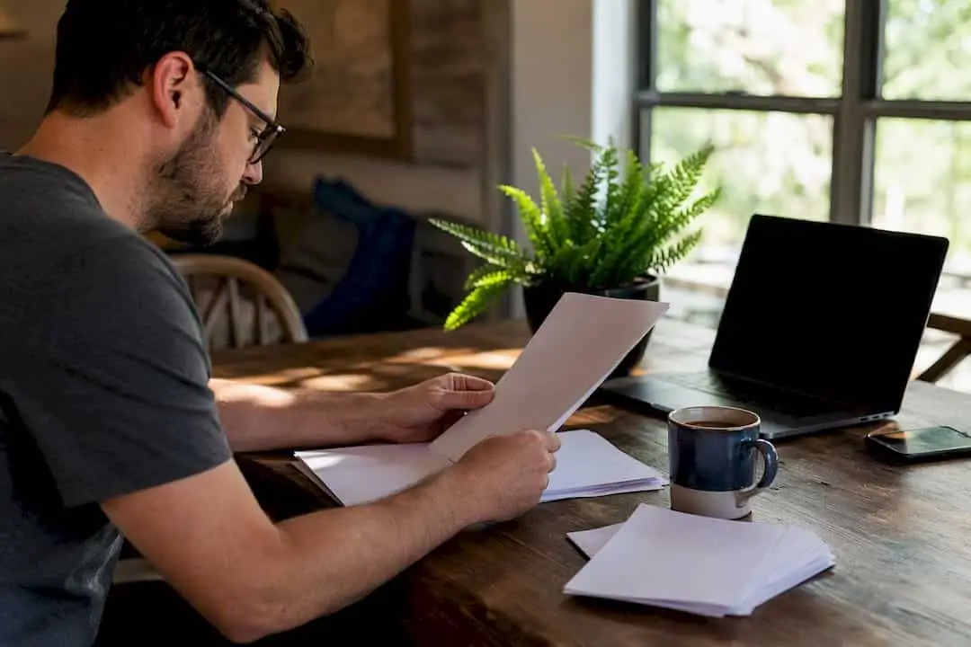 Freelancer organizing 1099 tax documents at desk