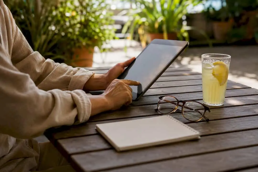Hands managing freelance finances on tablet