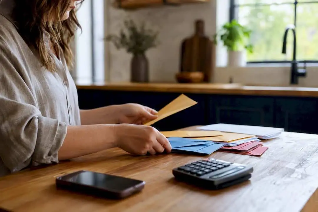 Hands sorting envelopes for down payment prep